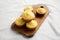 Homemade Cornbread Muffins on a rustic wooden board, low angle view