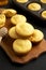 Homemade Cornbread Muffins on a rustic wooden board, low angle view. Close-up