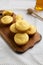 Homemade Cornbread Muffins on a rustic wooden board, side view