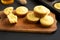 Homemade Cornbread Muffins on a rustic wooden board, side view. Close-up
