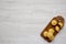 Homemade Cornbread Muffins on a rustic wooden board on a white wooden background, top view. Flat lay, overhead, from above. Copy