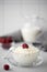 homemade cottage cheese with milk and raspberries in a glass bowl