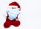 Homemade cotton Santa Claus play with a Covid-19 or Coronavirus protection mask