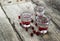 Homemade cranberry vodka, wooden background