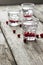 Homemade cranberry vodka, wooden background