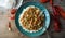 Homemade crawfish etouffee on a blue plate. Shown with whole boiled crawfish on a wood background. Directly overhead, copy space.