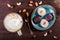 Homemade creamy fudge candies with coconut, raisins, nuts, sesame, peanut, served on the vintage plate with tea teapot. Top view