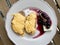 Homemade Creamy Scrambled Eggs in Breakfast Plate with Toast Bread, Cheese and Blackberry Jam