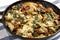 Homemade Creamy Tuscan Chicken in a cast iron pan, side view. Close-up