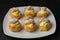 Homemade creme puff custard pastries topped with powdered sugar