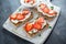 Homemade Crispbread toast with Cottage Cheese and Strawberry on white wooden board.