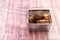 Homemade croquette inside small steel basket on top of a small pallet and with wood background