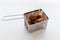 Homemade croquette inside small steel basket with white background