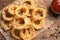 Homemade crunchy fried onion rings and sauce on wooden background