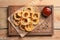 Homemade crunchy fried onion rings and sauce on wooden background