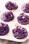 Homemade cupcakes with flower shaped purple cream