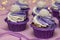 Homemade cupcakes with lilac cream on a pink background, concept for Valentines day or birthday, Closeup