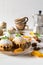 Homemade cupcakes with powdered sugar with cinnamon sticks, anise stars, and autumn leaves on white wooden table