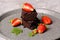 Homemade dark chocolate brownies decorated with strawberries