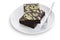 Homemade dark chocolate fudge brownies cake topping with almond slices on white isolated background with clipping path. Delicious