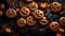 Homemade decorated cookies in the shape of scary golden pumpkins and black bats on dark scary background top view