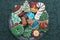 Homemade Decorated Cutout Christmas Cookies On Clear Plate,Green Tablecloth