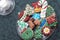 Homemade Decorated Cutout Christmas Cookies On Clear Plate,Green Tablecloth, Glass of Milk