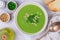 Homemade delicacy green pea soup cream with mint and pine nuts