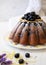 Homemade delicious and beautiful rustic Lemon Blueberry Cornmeal Cake served on a white plate