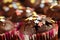 Homemade, delicious cocoa muffins with colorful sugar stars and dark chocolate icing. Extreme close up, shallow depth of field and