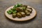 Homemade delicious stuffed grape leaves dolma with parsley in ceramic plat