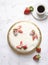 Homemade delicious sweet strawberry cake with red berries on cup of coffee americano, white background. Organic dessert