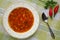 Homemade delicious traditional bulgarian bean soup bob chorba with pepper, tomatoes, onion and spices, served with red chili pep