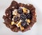 Homemade dessert with chocolate bowl, whipped cream, walnuts and