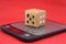 Homemade dice lie on a kitchen scale isolated on a red background, the unpredictability of financial markets.