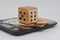 Homemade dice lie on a kitchen scale, the unpredictability of financial markets.