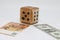 Homemade dice lies on banknotes, unpredictability of financial markets