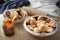 Homemade donuts with jam in bowl on wooden table