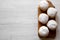 Homemade donuts with jelly and powdered sugar on rustic wooden board over white wooden table, top view. Copy space