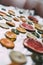 Homemade dried slices of various citrus fruits on a silver background