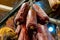 Homemade dry salami - traditional meat products, by smoked pork hanging in smokehouse