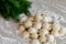 Homemade dumplings close-up. Dumplings lie on a table sprinkled with flour and next to dill greens