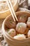 Homemade dumplings dim sum with stuffed shrimp close-up in a bamboo steamer box. vertical