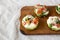 Homemade Egg White Breakfast Cups with Spinach and Tomato on a rustic wooden board, low angle view. Copy space