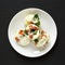 Homemade Egg White Breakfast Cups with Spinach and Tomato on a white plate on a black background, top view. Flat lay, overhead,