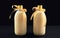 Homemade eggnog in bottles on dark background