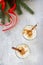 Homemade Eggnog Christmas milkshake with cinnamon, served in two cups on a stone or slate background, decorative ornaments,