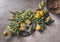 Homemade elder flower syrup with lemons, sugar, fresh lemon juice. Bundle of elder on decorated plate, kitchen equipment, dark