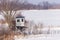 Homemade elevated hunting blind during winter with snow. Selective focus, background blur and foreground blur.