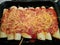 Homemade enchiladas with sauce and grated cheese